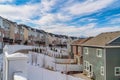 Townhouses with balconies and homes with fenced yards against cloudy blue sky Royalty Free Stock Photo