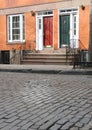 Townhouses on cobblestone street Royalty Free Stock Photo