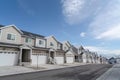 Townhouses on a scenic subrban landscape against lake mountain and cloudy sky