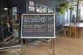 Blackboard Menu At Restaurant With Caged Birds And Garden Decor Royalty Free Stock Photo