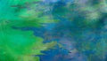 Toxic colours of oil and water in a chemical spill creating a psychedelic blur of rainbow colours. Royalty Free Stock Photo