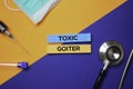 Toxic Goiter text on Sticky Notes. Top view isolated on color background. Healthcare/Medical concept
