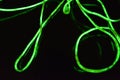 Toxic green lime lighting with a specific pattern. Woven filaments, cable, wires with outgoing light. Neon electroluminescent wire