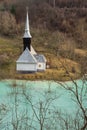 Toxic waste waters from a copper and gold mine submerge village. Abandoned orthodox church on lakeside