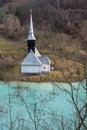 Toxic waste waters from a copper and gold mine submerge village. Abandoned orthodox church on lakeside