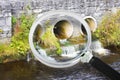 Toxic water running in concrete drainpipe towards the river - Concept image seen through a magnifying glass