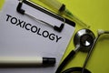 Toxicology on the Document with yellow background. Healthcare or Medical concept