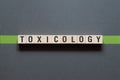 Toxicology - word concept on cubes