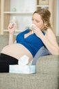 Toxicosis - pregnant woman lies on sofa