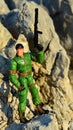 Toy action figure of GI Joe called Chief Torpedo standing on coastal rocks