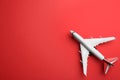 Toy airplane on red background, top view. Space for text Royalty Free Stock Photo
