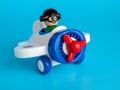 Toy airplane vintage propeller with pilot, on blue background, children`s toy Royalty Free Stock Photo
