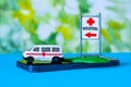 Toy ambulance car blue green hospital sign phone background