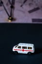 Toy ambulance car white black watch time background