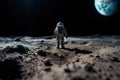 The toy of the astronaut stands on the moon\'s surface