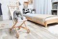 Toy baby buggy with bunny near floor bed. Montessori bedroom interior Royalty Free Stock Photo