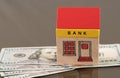 Toy bank building on US dollar assets Royalty Free Stock Photo