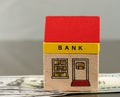 Toy bank building on US dollar assets Royalty Free Stock Photo