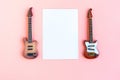 Toy bass and electric guitars and white mockup blank on pink background, top view Royalty Free Stock Photo