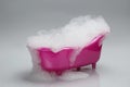 Toy bathtub overflowing with foam on grey background Royalty Free Stock Photo