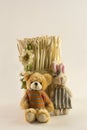 Toy bear and bunny sitting next to a bundle of brushwood Royalty Free Stock Photo
