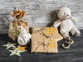 Toy bear, homemade Christmas gifts in Kraft paper, candy on a wooden surfaces. Royalty Free Stock Photo