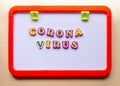 Toy blackboard with word coronavirus