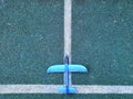 Toy blue airplane on grey background with white stripe background. Miniature toy airplane on blue background Royalty Free Stock Photo