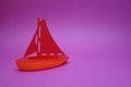 Toy boat on a pink background