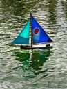 Toy Boat on Pond vertical