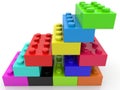 Toy bricks of different colors are connected to each other in an abstract pyramid construction Royalty Free Stock Photo