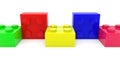 Toy bricks of different colors in one row on white Royalty Free Stock Photo