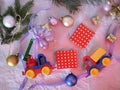 Toy bright cars, boxes with gifts, Christmas decorations, New Year`s decor, balls on a light background