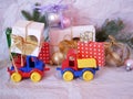 Toy bright cars deliver boxes with gifts, Christmas decorations, New Year`s deco