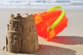 Toy bucket sandcastle on the sand of a beach Royalty Free Stock Photo