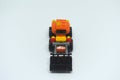 Toy bulldozer made from mostly orange and black plastic bricks.