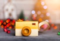 Toy camera on the table in the Christmas lights Royalty Free Stock Photo