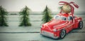 Toy car carrying christmas bauble ball on wooden plank Royalty Free Stock Photo