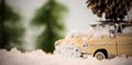 Toy car carrying pine cone on fake snow Royalty Free Stock Photo