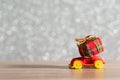 Toy Car with Christmas tree and gift box. Christmas landscape with gifts and snow. Merry christmas and happy new year greeting car Royalty Free Stock Photo