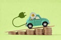 Toy car with daisy flower and electric plug on raising piles of coins - Concept of electric car and price increase