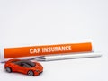 A toy car with defocused insurance paper behind and ball pen on white background Royalty Free Stock Photo