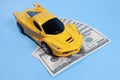 Toy car on dollars, cost concept, auto insurance Royalty Free Stock Photo