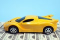 Toy car on dollars, cost concept, auto insurance Royalty Free Stock Photo