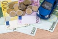 Toy car with euro bills and coin. Royalty Free Stock Photo