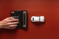 Toy car and hand counting on a calculator on a maroon background, the concept of selling and buying a car Royalty Free Stock Photo