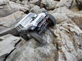 Toy car Jeep Wrangler on stones by the lake with a view of nuclear power plant