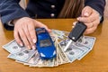 Toy car and keys in female hands on dollar notes Royalty Free Stock Photo