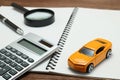 Toy car, magnifying glass, calculator, pen and notebook. Royalty Free Stock Photo