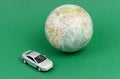 Toy car near the globe. Travel and ecology. Royalty Free Stock Photo